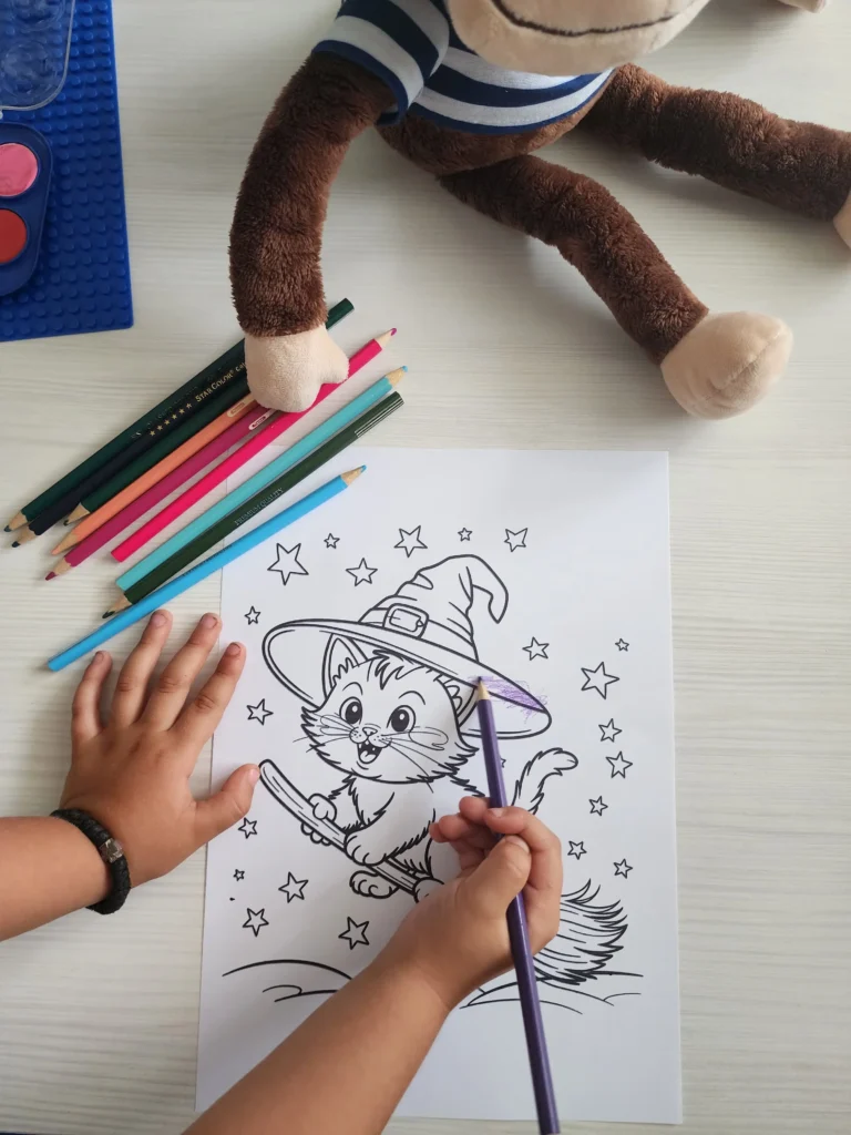 25 Fun Things to Do in October – Cozy Fall Vibes & Halloween Prep 4 Child coloring a Halloween printable page with crayons, cozy family fall activity from the Halloween Cozy Kit